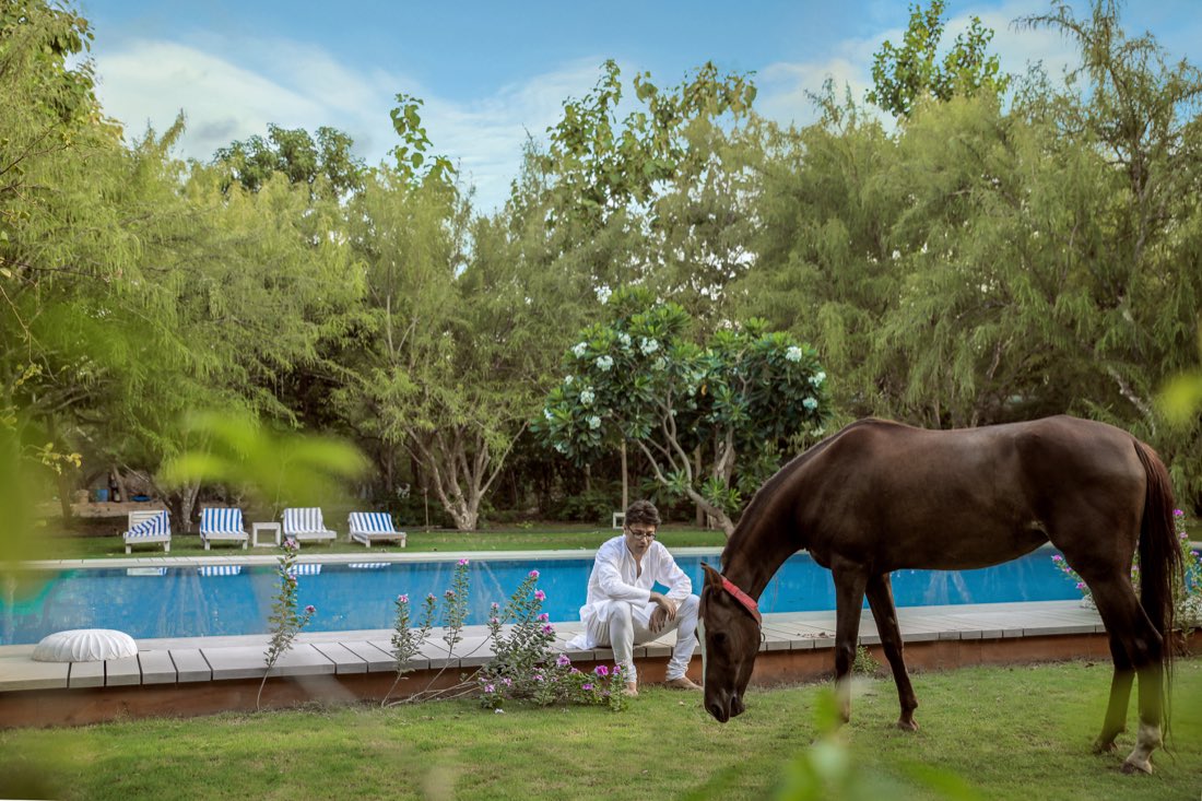 Udai with horse by the pool